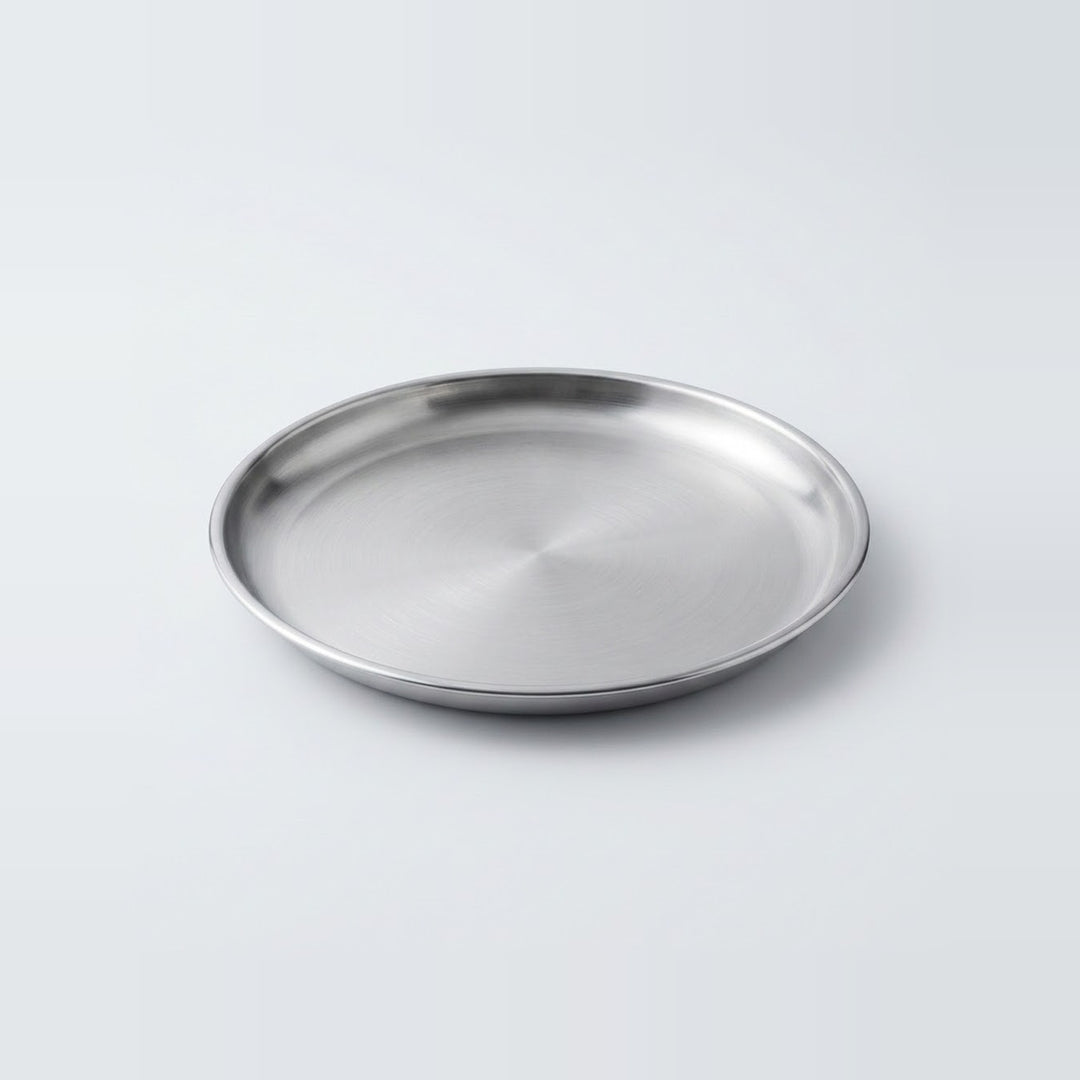 A round stainless steel tray with a brushed metallic finish, photographed on a clean light gray background.