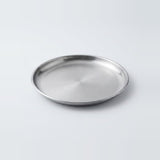 A round stainless steel tray with a brushed metallic finish, photographed on a clean light gray background.
