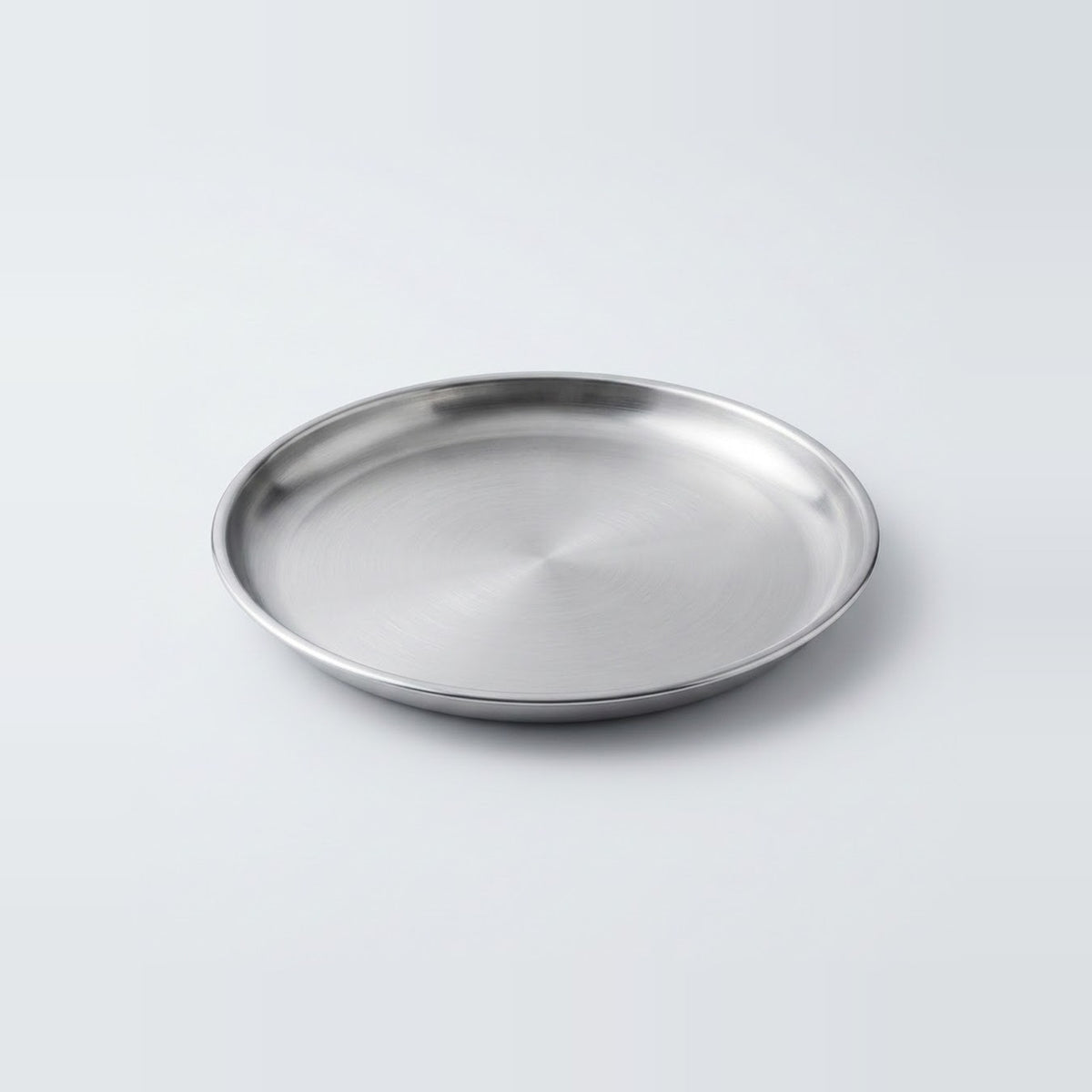 A round stainless steel tray with a brushed metallic finish, photographed on a clean light gray background.