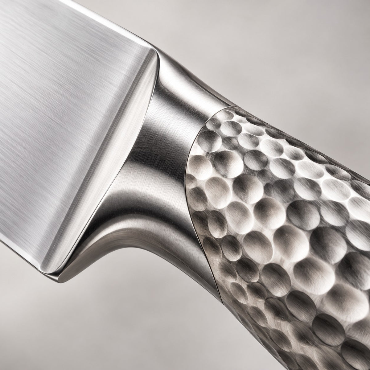 14-piece knife block set close-up shows the hammered stainless steel handle and polished blade finish.