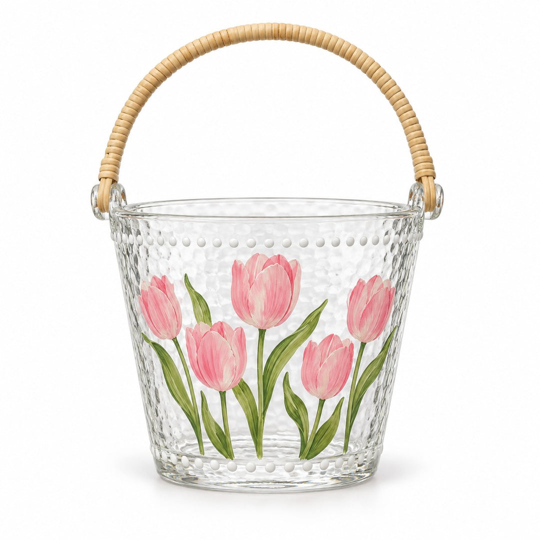 Single tulip glass ice bucket with its attached rattan-woven handle on white.