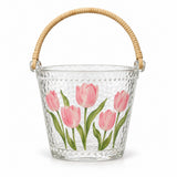 Single tulip glass ice bucket with its attached rattan-woven handle on white.