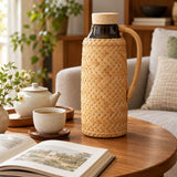 Bamboo Glass-Lined Thermos sits beside a cup and book, ready for an afternoon tea break.