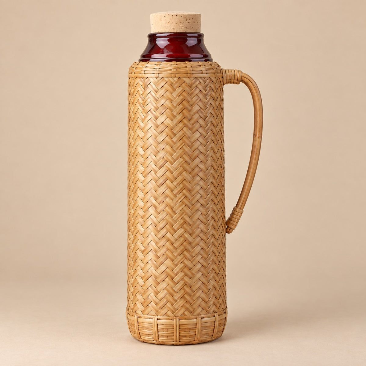 Tan Weave, Red Liner thermos displayed upright with its tall woven body and handle.