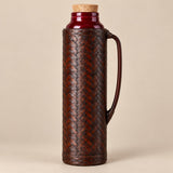Brown Weave, Red Liner thermos displayed with its dark woven finish and curved handle.
