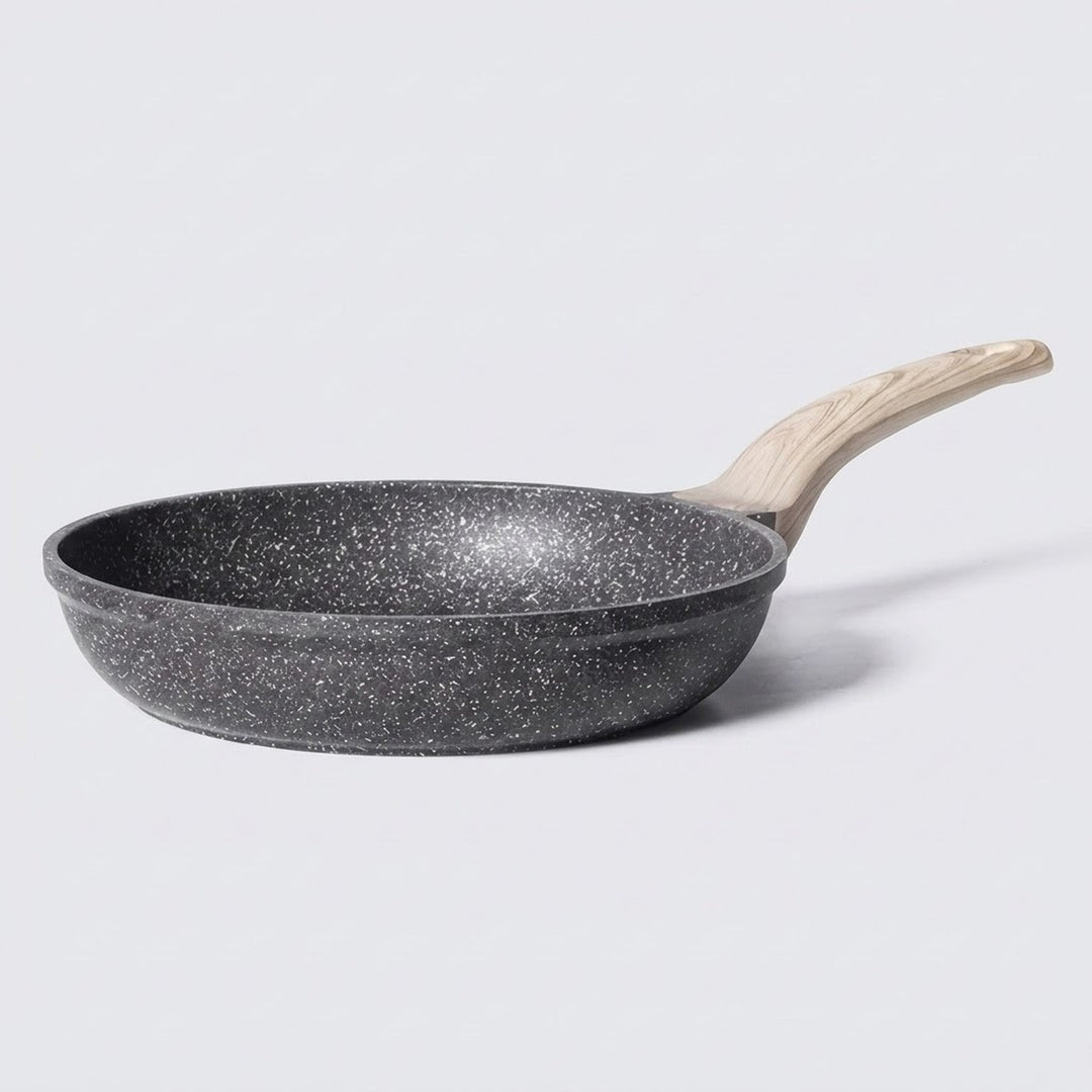A non-stick frying pan with a dark gray speckled exterior and a light natural wood handle, shown on a light gray background.