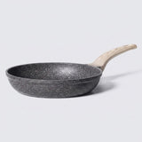 A non-stick frying pan with a dark gray speckled exterior and a light natural wood handle, shown on a light gray background.