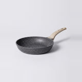 A dark gray non-stick frying pan with a speckled exterior and a light natural wood handle, shown on a clean light gray background.