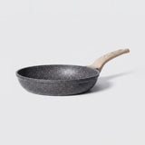 A dark gray non-stick frying pan with a light natural wood handle, shown from a side angle on a light gray background.