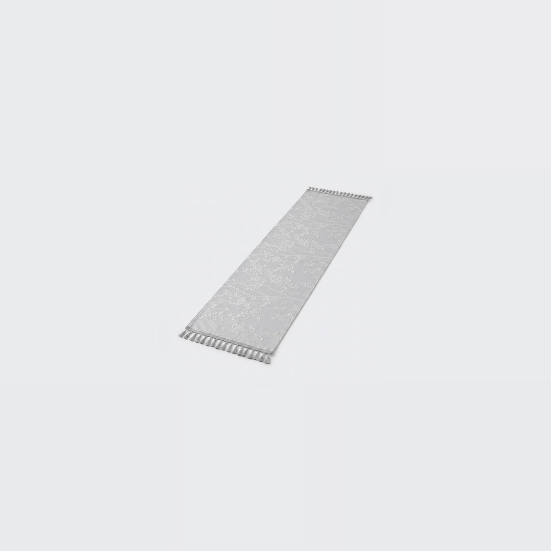 A long, narrow rectangular gray textured strip with small white zigzag cutouts along both short ends, shown on a plain light gray background.