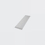 A long, narrow rectangular gray textured strip with small white zigzag cutouts along both short ends, shown on a plain light gray background.
