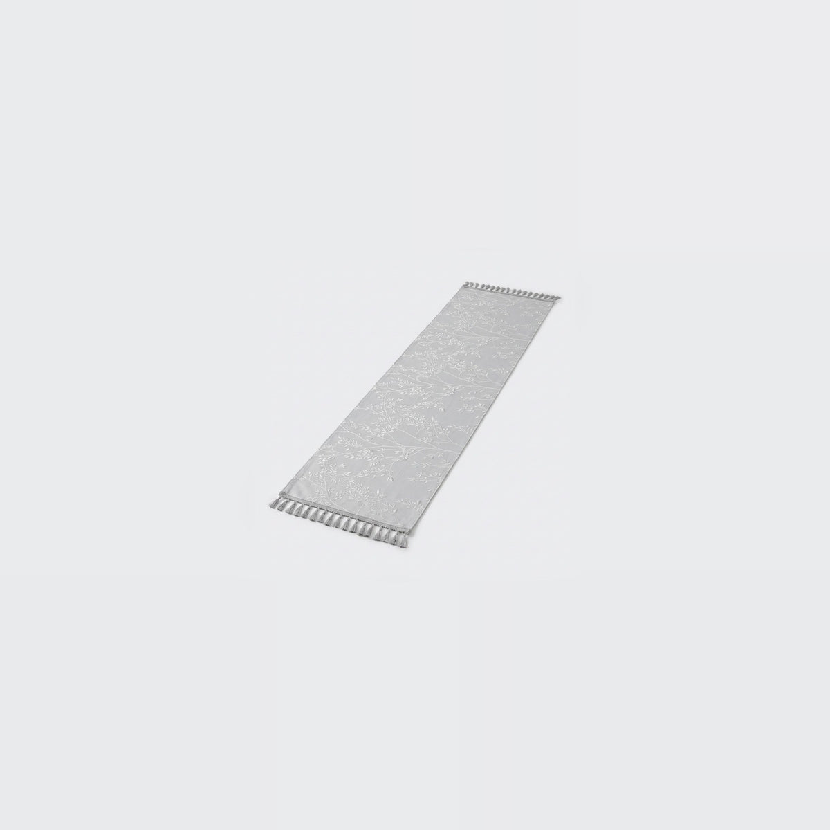 A long, narrow rectangular gray textured strip with small white zigzag cutouts along both short ends, shown on a plain light gray background.