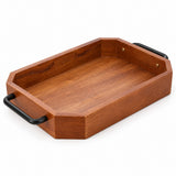 One empty rectangular wooden serving tray with black iron handles stands alone on white.