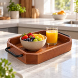 Wooden serving tray organizes fruit and juice on a bright kitchen counter for breakfast.