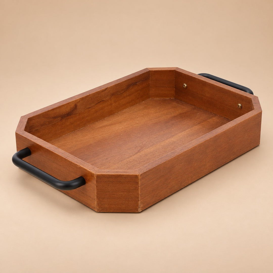 Rectangular coffee-brown wooden serving tray with black iron handles on a soft beige studio backdrop.