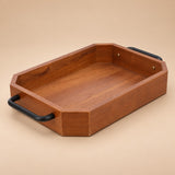 Rectangular coffee-brown wooden serving tray with black iron handles on a soft beige studio backdrop.