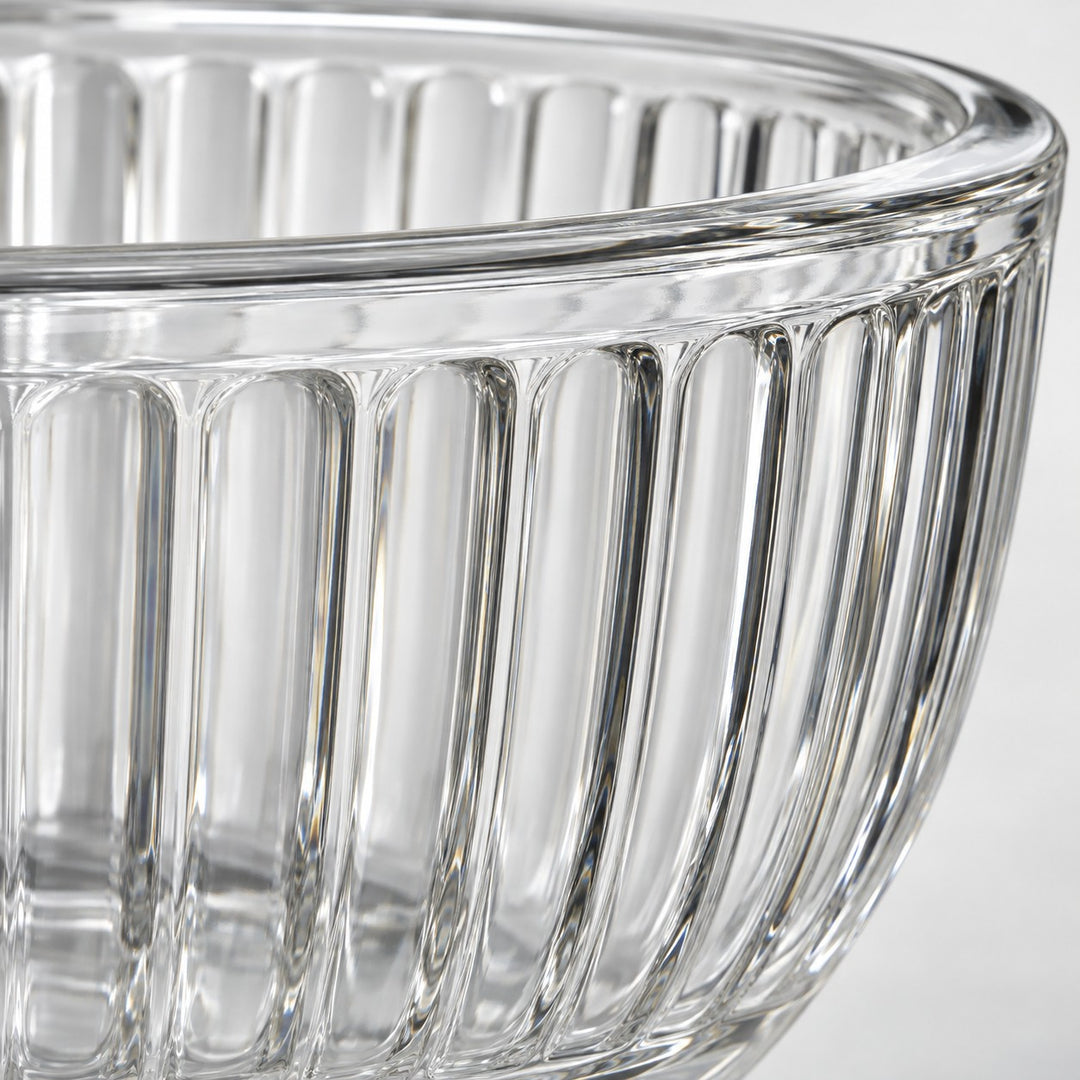 Close-up of the thick clear glass rim and fluted finish on a mixing bowl.