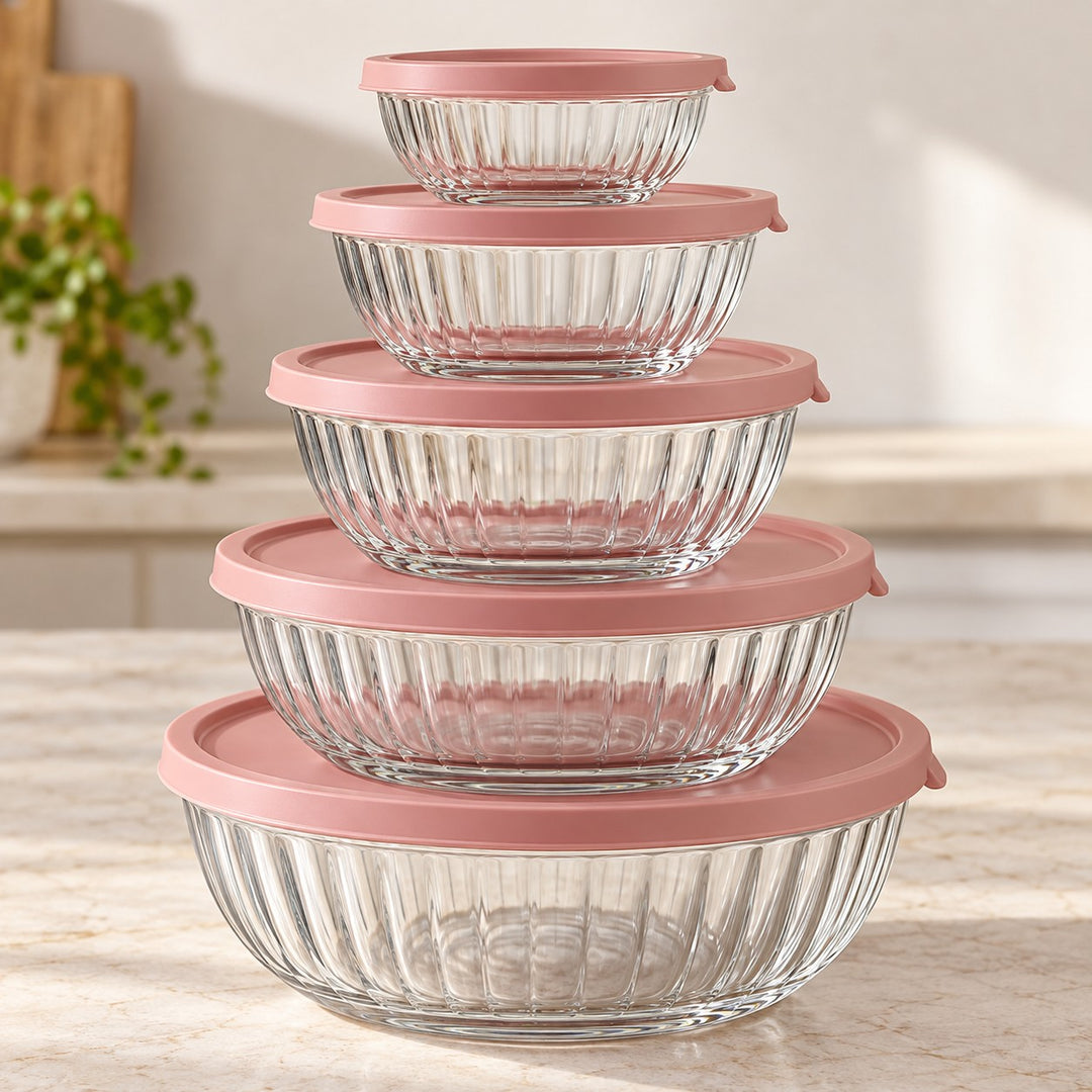 Five ribbed glass mixing bowls nest together with matching rose lids for compact storage.