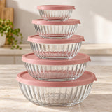 Five ribbed glass mixing bowls nest together with matching rose lids for compact storage.