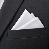 A crisp white polyester pocket square sits in a layered fold on a charcoal suit, showing its clean solid color.