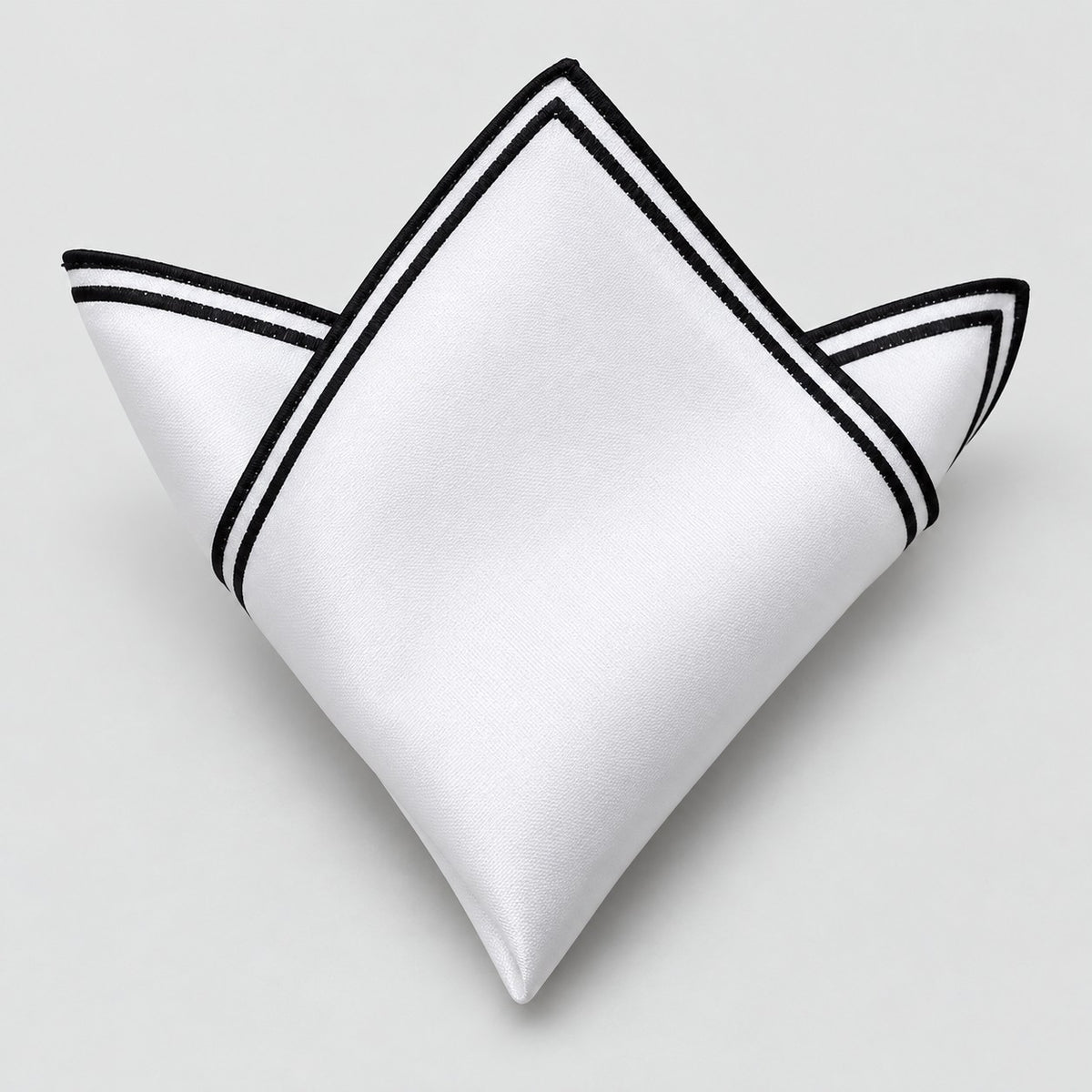 One white polyester pocket square with a double black border is folded on a pale gray background.