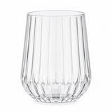 One clear stemless ribbed plastic wine glass stands alone on a white background.