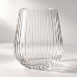 Clear ribbed stemless plastic wine glass highlights its textured sides on a bright studio backdrop.