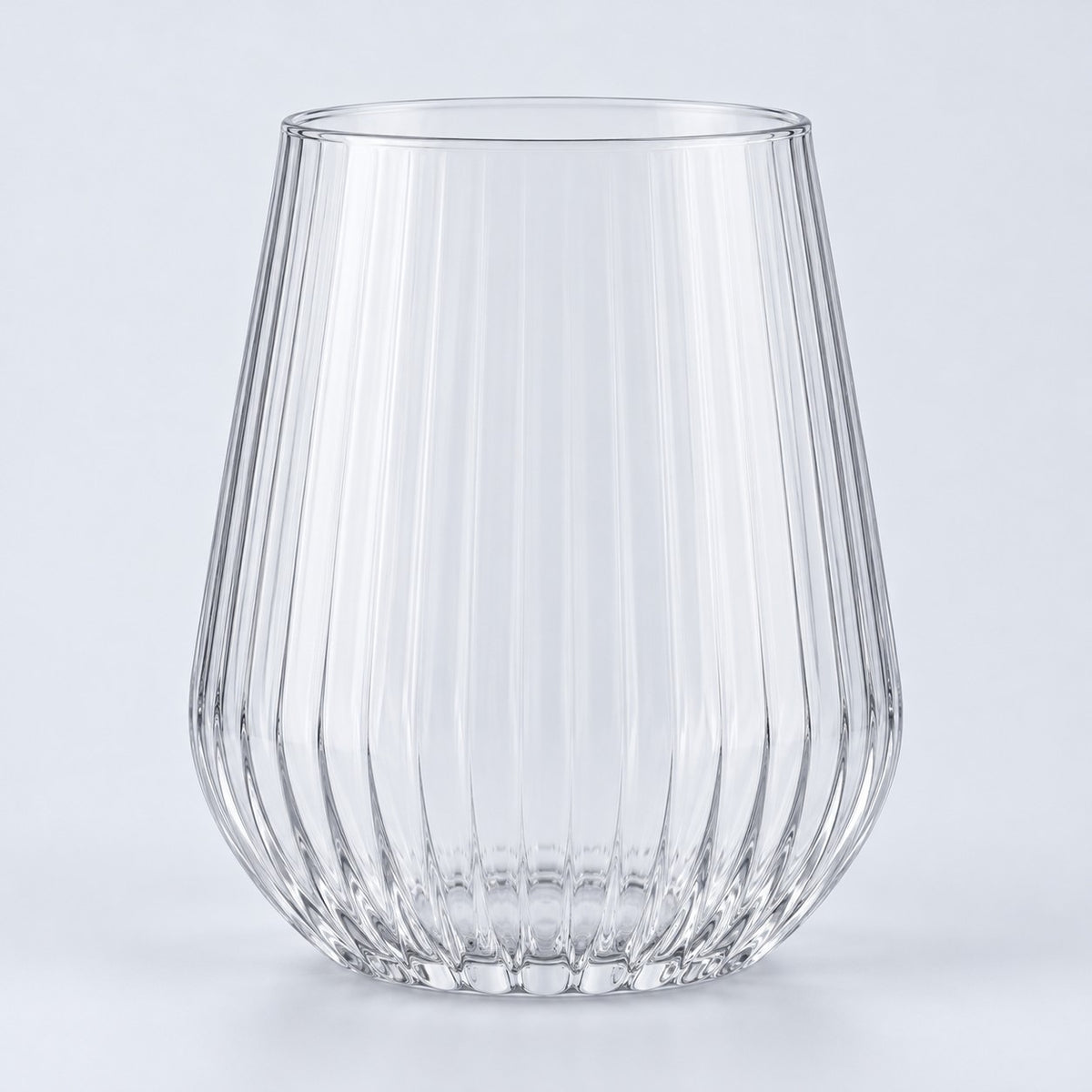 Single clear-rim stemless ribbed plastic wine glass centered on a pale gray backdrop.