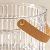 Clear Ice Bucket with Handle close-up reveals glossy fluting and faux leather strap.