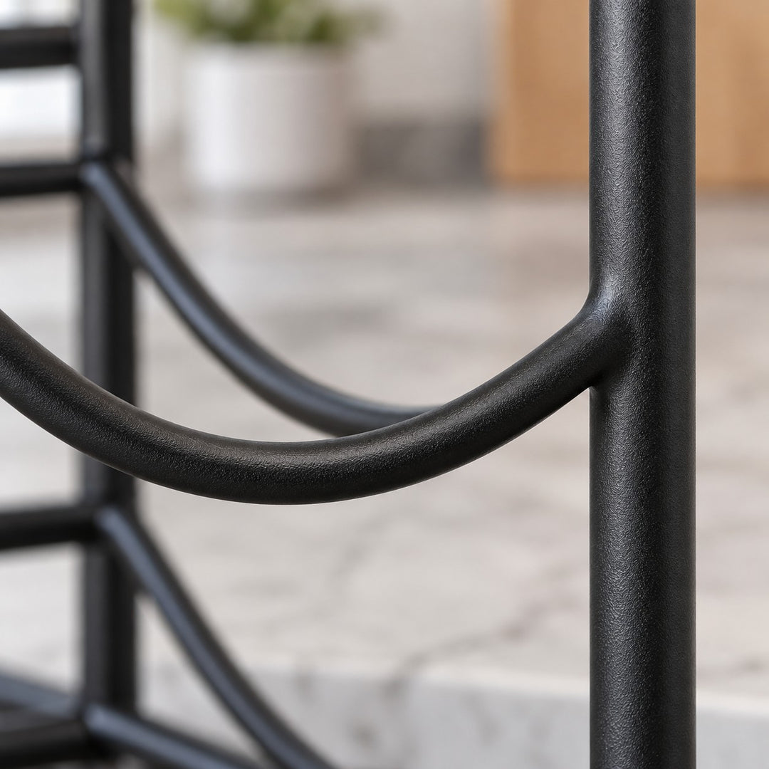 Close-up of the black iron organizer shows its smooth coated finish and curved bottle cradle.