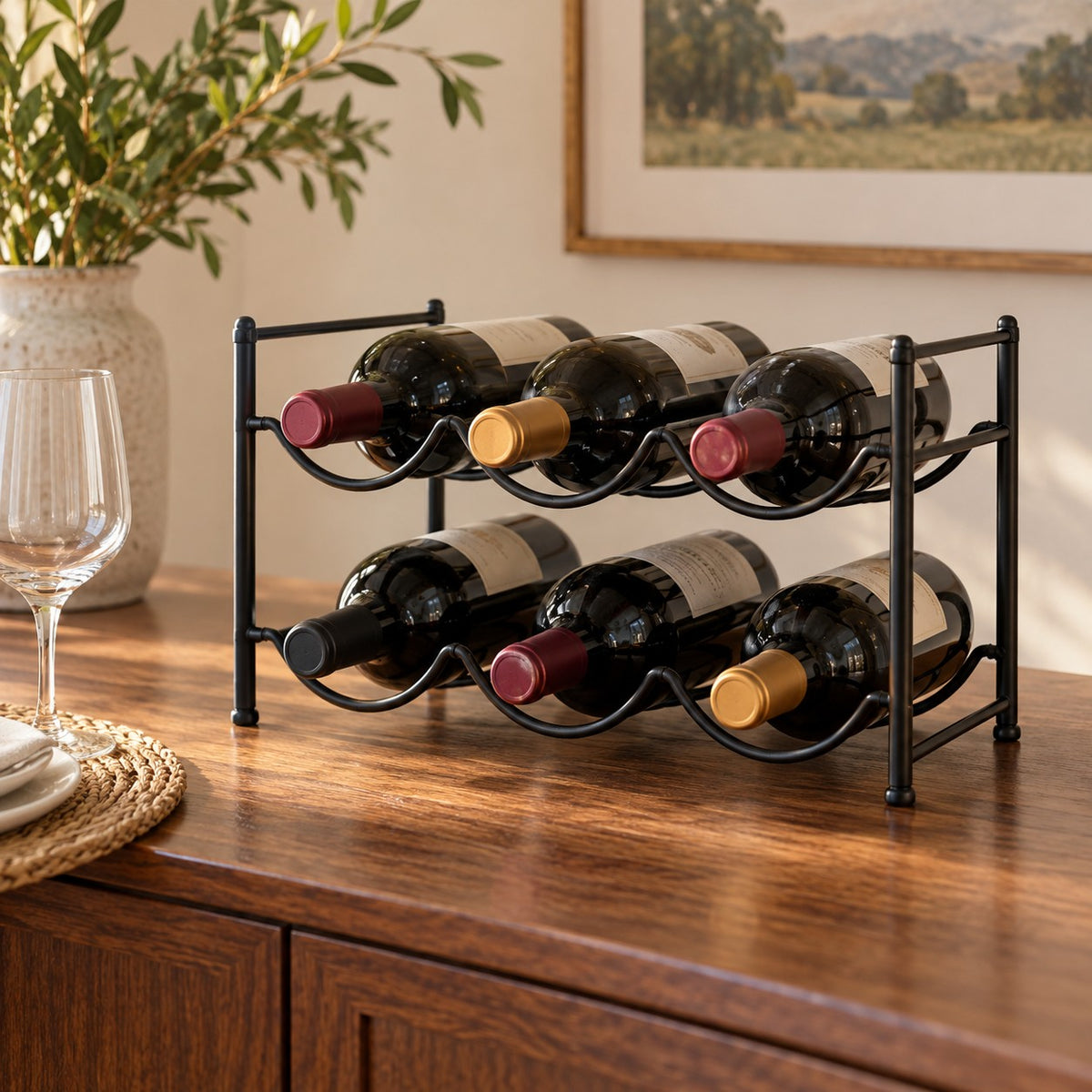 Black two-tier bottle organizer holds wine bottles horizontally on a warm dining sideboard.