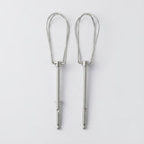 Two silver metal whisk attachments for mixing or whipping, shown side by side on a light gray background.