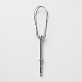 A stainless steel kitchen utensil with a long straight handle and a looped head, shown vertically against a plain light gray background.
