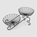 Black metal wire double-tier bowl stand on a light gray background.