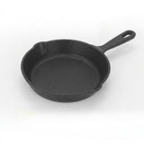 Black cast iron skillet on a white background
