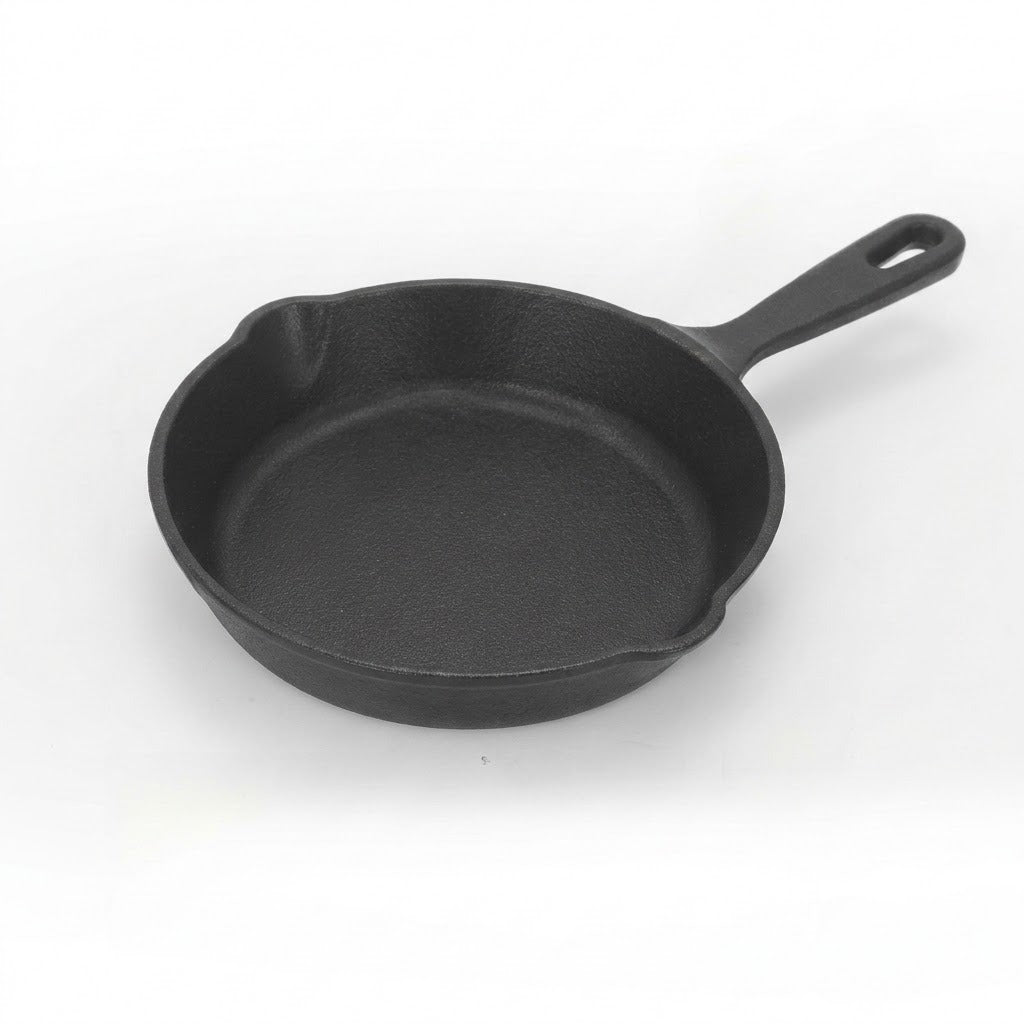 Black cast iron skillet on a white background