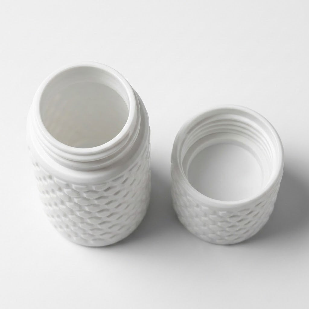 A white textured plastic jar with its threaded lid removed, showing the open jar and separate lid on a clean white background.