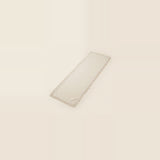A long rectangular cream-colored fabric runner with a delicate fringed edge, shown on a solid cream background.