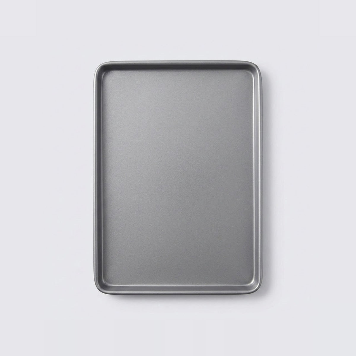 A rectangular metal baking sheet with raised edges, shown from a top-down view on a light gray background.