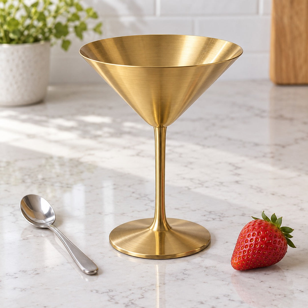Gold Stainless Steel Martini Cup sits beside a dessert spoon and strawberry to show its compact scale.