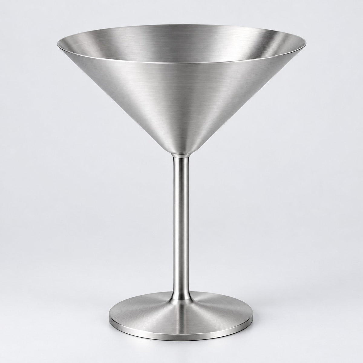 Silver Stainless Steel Martini Cup stands centered against a soft silver gray studio backdrop.