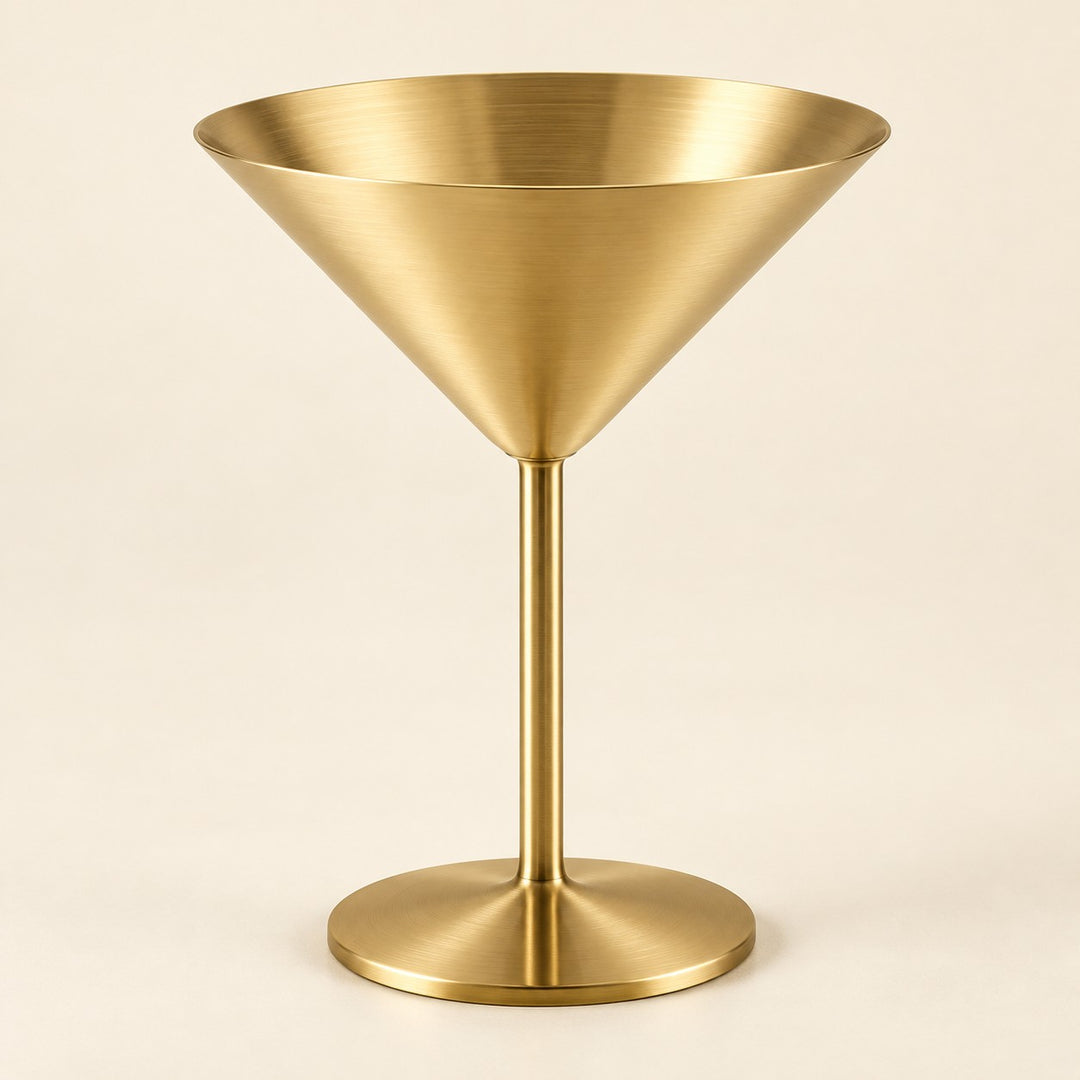 Gold Stainless Steel Martini Cup stands centered against a light gold ivory studio backdrop.
