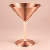 Copper Stainless Steel Martini Cup stands centered against a pale copper blush studio backdrop.