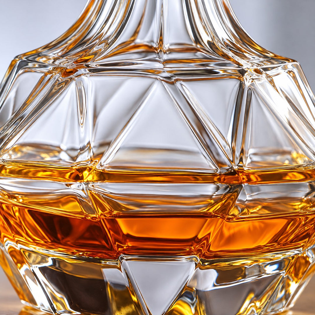 Macro of the Diamond Square decanter's clear polished glass and diamond cuts around amber whiskey.