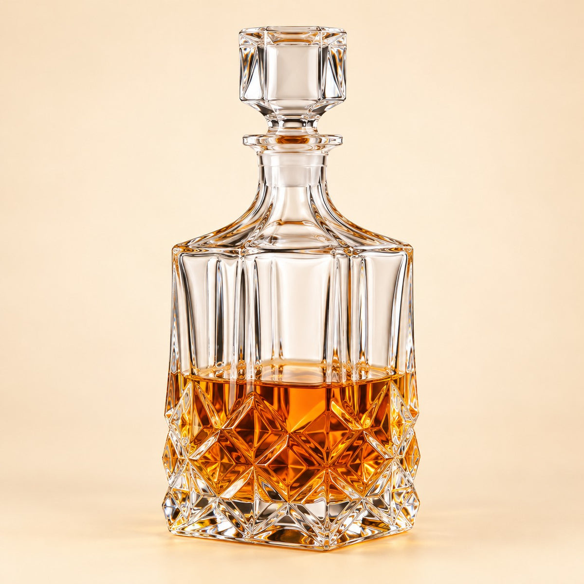 Diamond Square glass whiskey decanter with square stopper and cut body on a pale warm backdrop.