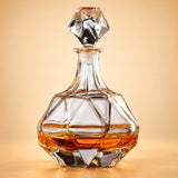 Faceted Globe glass whiskey decanter with polygonal stopper on a pale warm backdrop.