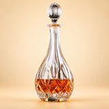 Diamond Teardrop glass whiskey decanter with fluted stopper on a pale warm backdrop.