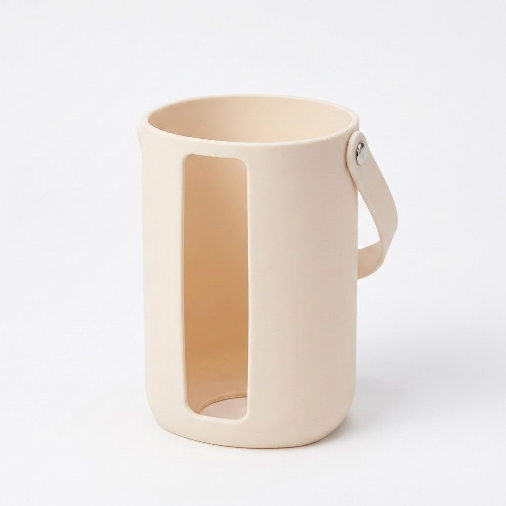 A minimalist beige silicone mug with a large vertical cutout and a matching handle, shown on a clean white background.