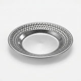 A round silver metal plate with a textured, dimpled border and a smooth, slightly beveled center, shown on a light gray background.