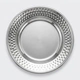 A round silver metal plate with a smooth center and a raised rim covered in a dense pattern of small raised dots, shown from a top-down view on a light gray background.